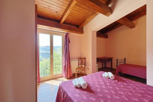 a bedroom with a purple bed and a large window at Bed And Breakfast Sciarammola in Patti