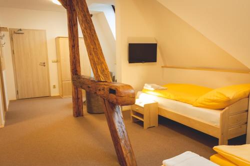 a bedroom with a bunk bed with yellow sheets at Penzion Vila Machů in Kopřivnice