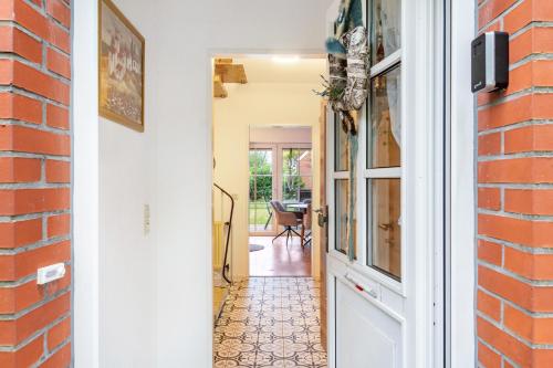 a hallway of a home with a brick wall at Ferienhaus Franz in Jemgum