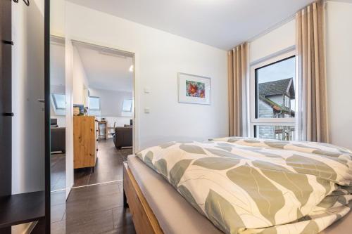 a bedroom with a bed and a large window at Ferienwohnung Lampa in Wasbüttel