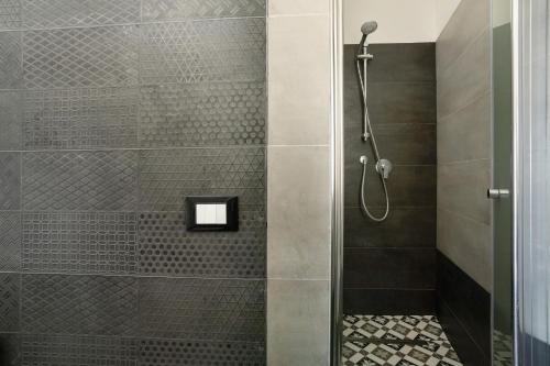 a shower with a glass door in a bathroom at Casa Merlino in Biassa