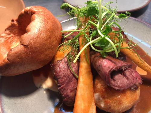 a plate of food with a sandwich and a carrot at The Crafty Cow in Bristol