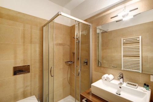 a bathroom with a sink and a shower at Kriendl Nr 1 in Valdaora