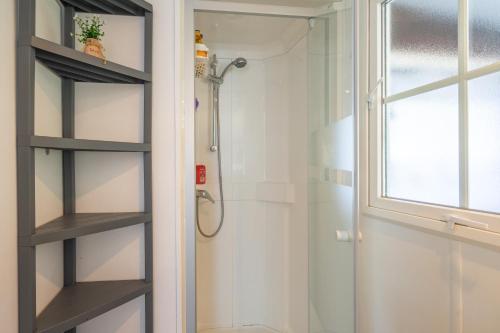 a bathroom with a shower and a glass door at Mh 229 La Tremblade in La Tremblade