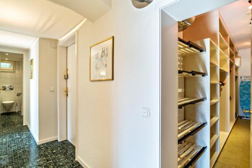 a walk in closet with white walls and shelves at Merkurblick in Baden-Baden
