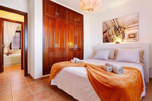 a bedroom with a bed with two towels on it at Vista de Lobos in Corralejo