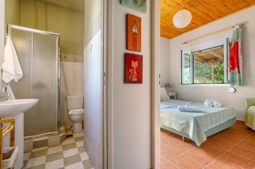a bathroom with a bed and a toilet and a sink at Ktima Dilberaki in Lixouri