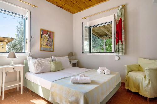 a bedroom with two beds and a window at Ktima Dilberaki in Lixouri