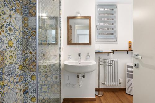 a bathroom with a sink and a shower at Suite Strada Persa in Pavia