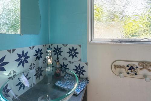 a bathroom with a glass sink and a window at Mh310 La Tremblade in La Tremblade