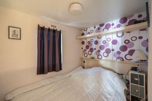 a bedroom with a bed and a window at Mh310 La Tremblade in La Tremblade