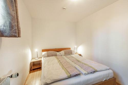 a bedroom with a bed with two pillows on it at Zwei-Zimmer-Wohnung in Schopfheim in Schopfheim