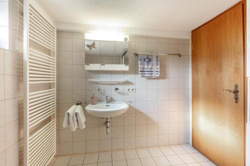 a bathroom with a sink and a mirror at Zwei-Zimmer-Wohnung in Schopfheim in Schopfheim