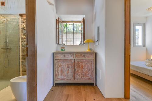 a bathroom with a tub and a sink and a mirror at Casa Magnolia Loft in Seccheto
