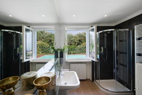 a bathroom with a tub and a sink and a shower at Villa Savi Lake View and Pool in Torri del Benaco