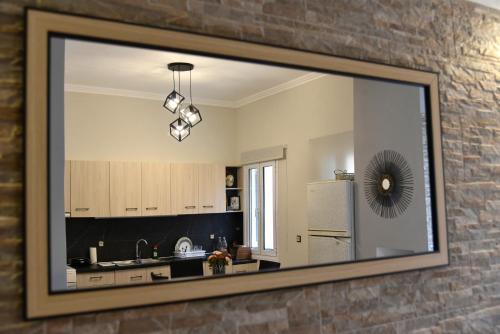 a mirror on the wall of a kitchen at Nicol apartment in Koustáros