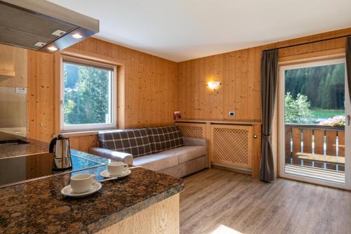 a living room with a couch and a table at Stoffel Apartments Martina in Selva