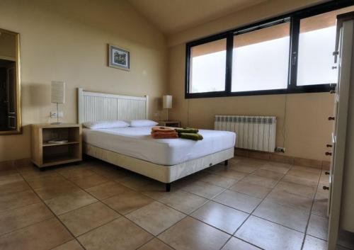 a bedroom with a bed and two windows at Royal Horizón Dúplex in Navata