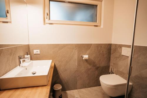 a bathroom with a sink and a toilet at Apartment Toni - Obermösslhof in Lana