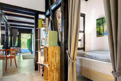 a room with a bed and a tv in it at Wohnen im Heidehaus in Sankt Dionys