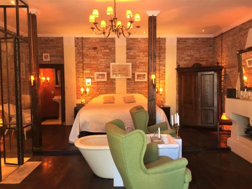 a bedroom with a bed and a tub in a room at Zabola Estate - Transylvania in Zăbala