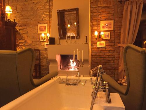 a bathroom with a bath tub with candles in it at Zabola Estate - Transylvania in Zăbala