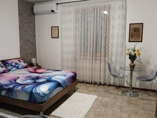 a bedroom with a bed and a table and chairs at Il SORRISO in Moie