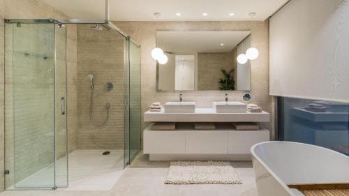 a bathroom with a shower and a sink and a mirror at Villa 11 Sunset in Marbella
