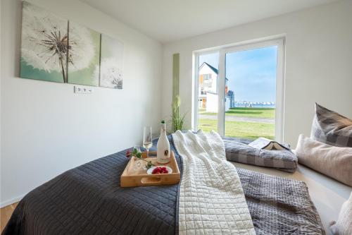 a bedroom with a bed with a tray of food on it at Fewo Meerwert by Seeblick Ferien in Kappeln