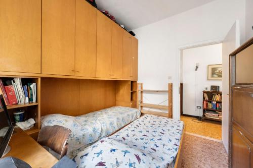 a bedroom with a bed and a book shelf at Apartment Beach next to 5 Terre in Bonassola