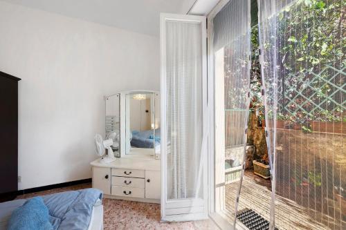 a bedroom with a mirror and a sink and a window at Apartment Beach next to 5 Terre in Bonassola