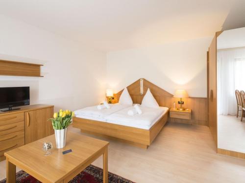 a hotel room with a bed and a table at Fewo Schneckenhalde App 12 in Bad Säckingen