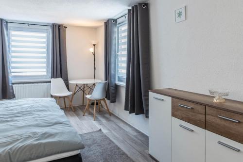 a bedroom with a bed and a table with chairs at Mina in Krauchenwies