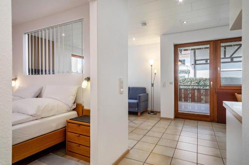 a hotel room with a bed and a bathroom at Gästehaus Heinemann - Eg3 in Langenargen