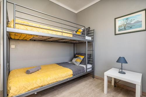 a bedroom with two bunk beds and a table at Casa Quintião in Ferragudo