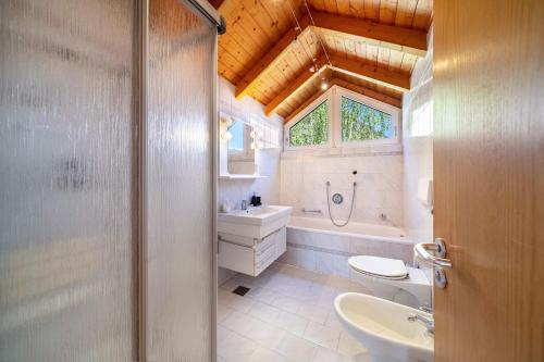 a bathroom with a toilet and a sink and a shower at Apartment Luisa in Silandro