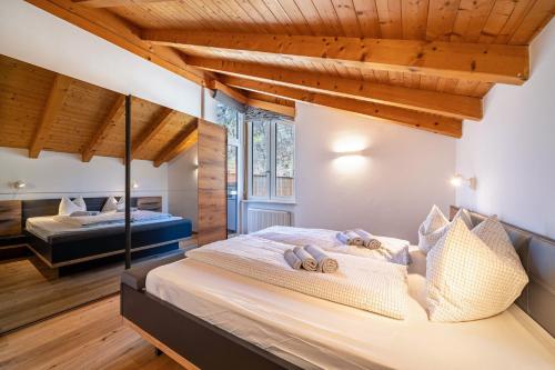 a bedroom with a large bed with wooden ceilings at Apartment Luisa in Silandro
