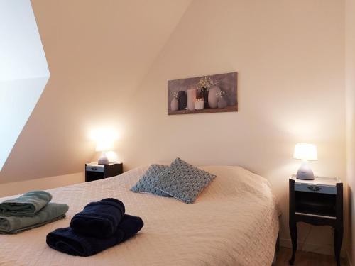 a bedroom with a bed with two pillows on it at le Nid perché in Brou