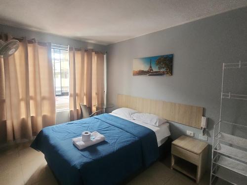 a bedroom with a blue bed with a tray on it at Hospedaje costa pacífico in Chimbote