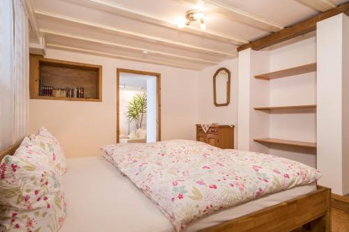 a bedroom with a bed with a pink comforter at Ferienwohnung im alten Forsthaus in Bermatingen