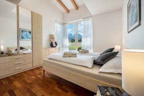 a large bed in a bedroom with a large window at Suite Marianne in Valdaora