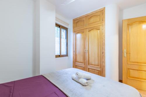 a bedroom with a bed with two towels on it at Tosca Mar 223 in Moraira