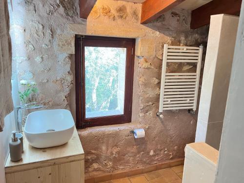 a bathroom with a sink and a window at Casa Pina in Costitx