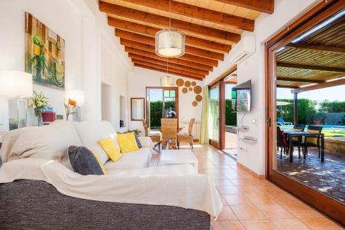 a living room with a white couch and a table at S'Hostalet in Islas Baleares