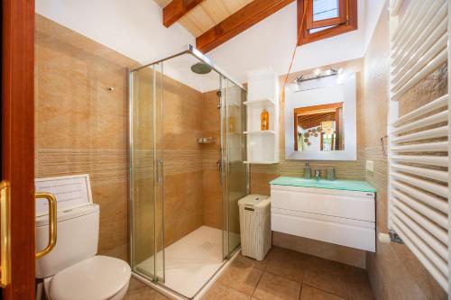 a bathroom with a shower and a toilet and a sink at S'Hostalet in Islas Baleares
