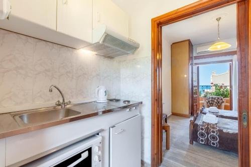a kitchen with a sink and a view of a patio at Mires House Side First Floor 10 in Agios Gordios