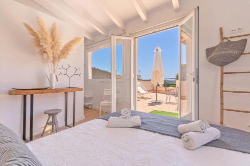 a bedroom with a bed and a view of the ocean at Es Clos in El Port de la Selva