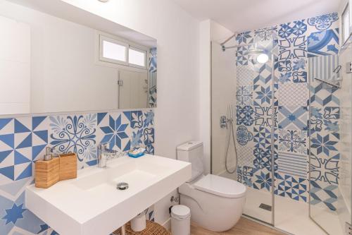 a bathroom with a sink and a toilet and a shower at Es Clos in El Port de la Selva