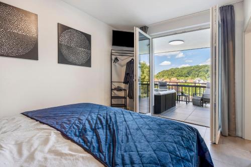 a bedroom with a bed and a balcony at Egge Resort 7b mit Whirpool u Sauna in Altenbeken