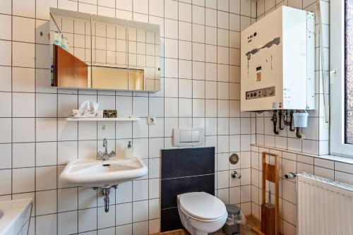 a bathroom with a toilet and a sink at Haci Babas Home in Bestwig